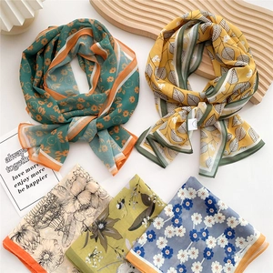 Fashionable long silk scarf for women featuring colorful floral prints and lightweight fabric