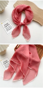 Detail of dusty rose thin square silk scarf with delicate hem and soft chiffon texture