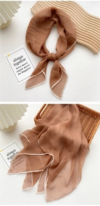 Detail of sheer brown silk scarf texture and high-quality edge stitching with brand label