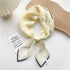 Elegant cream square silk scarf with black piping and abstract lines in a stylish bow knot