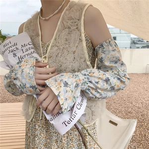 Detailed view of floral sun protection sleeves with delicate beige lace trim finish