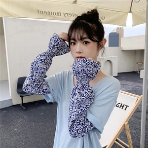 Close-up of floral ice silk sun sleeves with blue leaf patterns and ruffled cuffs