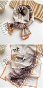 Detailed view of long silk scarf featuring Chinese landscape print and orange hem