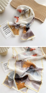 Detail of thin landscape print scarf with orange trees and soft fabric texture