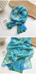 Detail of artistic long scarf showing Van Gogh's almond blossom print on light blue chiffon