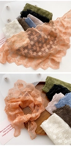Close-up of lace scarves set with floral embroidery and wavy edges in various colors