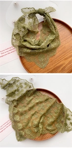 Detailed view of grass green lace scarf with 3D floral embroidery and scalloped edges