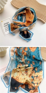 Detail of silk scarf with peacock blue and orange leaf patterns in vintage French style