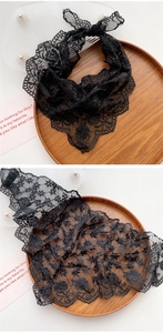 Macro view of black floral crochet lace texture with delicate scalloped edges