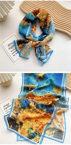 Detail of oil painting style silk scarf featuring vibrant blue and yellow contrast patterns