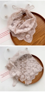 Close-up of light pink lace floral headband with fine crochet patterns and scalloped edges