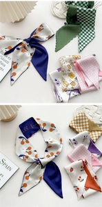 Detailed view of patterned silk headbands with cherry, floral and checkered designs