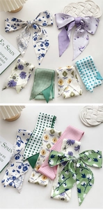 Close-up of assorted floral silk scarves and ribbons used as hair bands and bag accessories