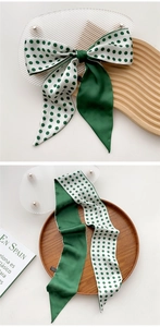 Detail of silk hair scarf showing green satin and white polka dot patchwork design
