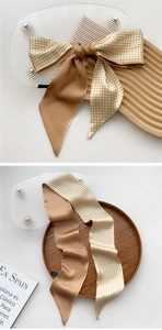 Detail of silk scarf with yellow gingham pattern and caramel satin reverse side