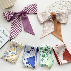 Narrow printed silk scarves for hair and bags in floral and purple checker patterns