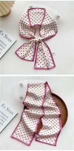 Detail of silk-feel skinny scarf with burgundy polka dots and matching stitched edges