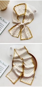 Close-up of yellow polka dot silk scarf detail with wash label and elegant stitching