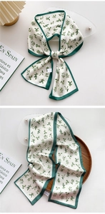 Detail showing high-quality satin silk scarf with green floral print and elegant borders