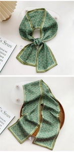 Detail view of a green long silk scarf with white geometric chain pattern and fine edges