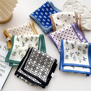 Multiple printed silk-like scarves in vibrant colors and patterns for versatile styling