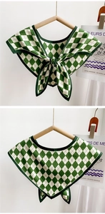 Detail view of green and white gingham scarf collar with a bow tied on a hanger