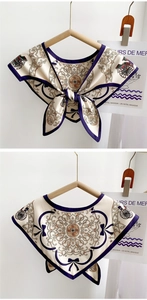 Detail of vintage French style silk scarf with horse carriage print and bow accents
