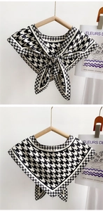 Detail of black and white houndstooth scarf neck wrap with ties on wooden hanger