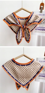 Close-up of vintage orange and blue trim silk scarf neckerchief with M-letter pattern