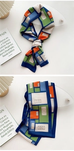 Detail of a geometric color-block silk twilly scarf with elegant French style and smooth texture