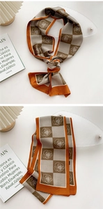Detail of a vintage orange silk scarf featuring rose patterns and houndstooth texture
