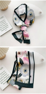 Detailed view of elegant floral long scarf with pink flowers and striped border detail