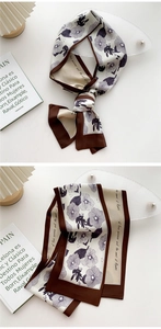 Macro detail of elegant floral satin twilly scarf with printed script and silk texture