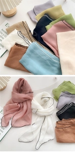 Close-up of lightweight chiffon skinny scarves with delicate wavy contrast stitched edges
