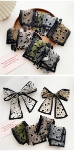 Detail of vintage organza bow hairbands with retro leaf patterns and mesh texture