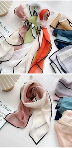 Detail of multi-colored long chiffon scarves with black stitched edges and soft drape