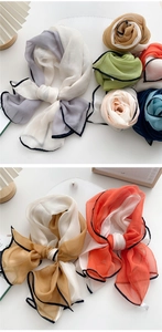 Close-up of lightweight chiffon scarves showing premium textures and rolled edge details