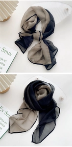 Detail of elegant two-tone chiffon scarf showing light texture and delicate stitching