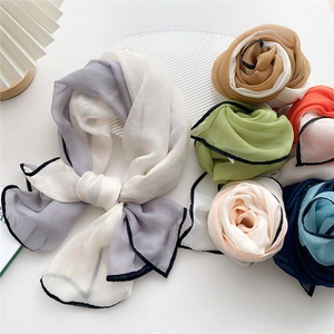 Long solid color silk scarf with black contrast borders in multiple elegant colors