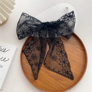 Elegant black lace bow hair clip with floral embroidery and long flowing ribbons