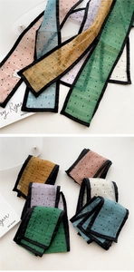 Detailed view of colorful polka dot mesh scarves with delicate black ribbon edging