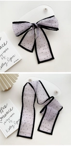 Close-up of elegant lavender mesh scarf with black polka dots and delicate stitched edging