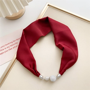 Detail of burgundy silk scarf featuring silver hardware and sparkling crystal beads