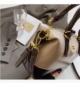 Detail of high-gloss gold hardware and two-tone leather texture on a vintage bag