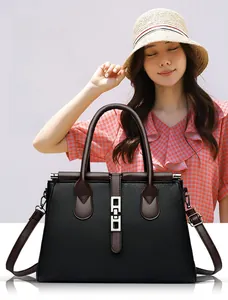 Detail of vintage tote bag showing pebble grain leather and silver rectangular lock