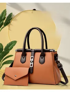 Close-up of brown pebbled cowhide leather tote bag with matching envelope pouch
