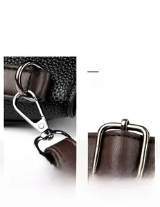 Close-up of polished silver hardware with black lychee grain texture and brown strap