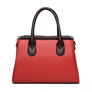 Classic red pebble leather tote bag with dark brown handles in a trapezoidal shape