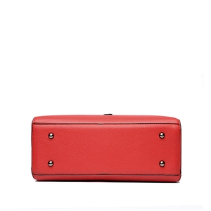 Red pebbled leather tote bag base with four protective gunmetal studs on white background
