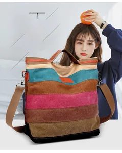 Detail of colorful striped canvas tote bag with leather logo patch and crossbody strap